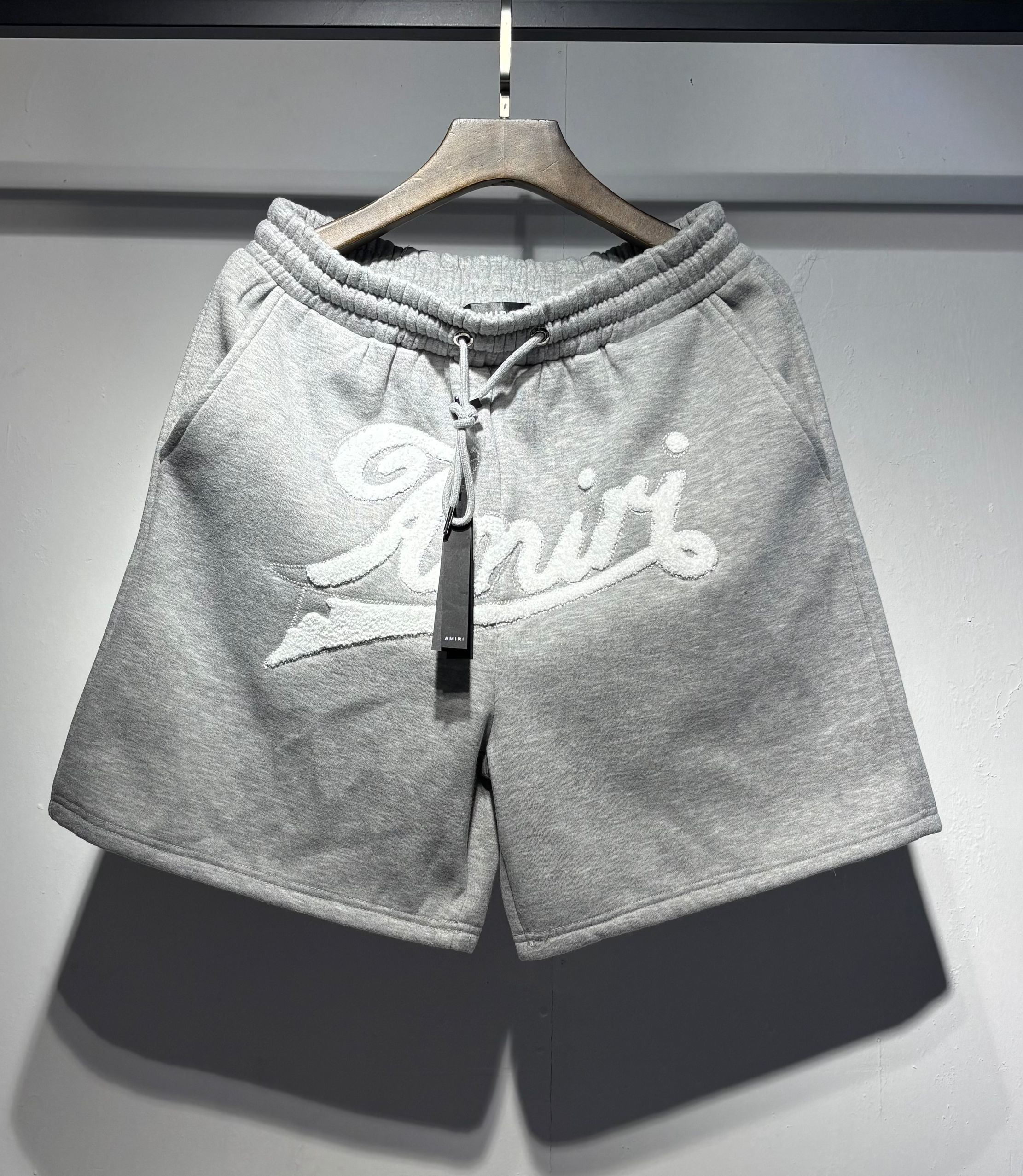 Grey graffiti-style printed and outlined logo shorts