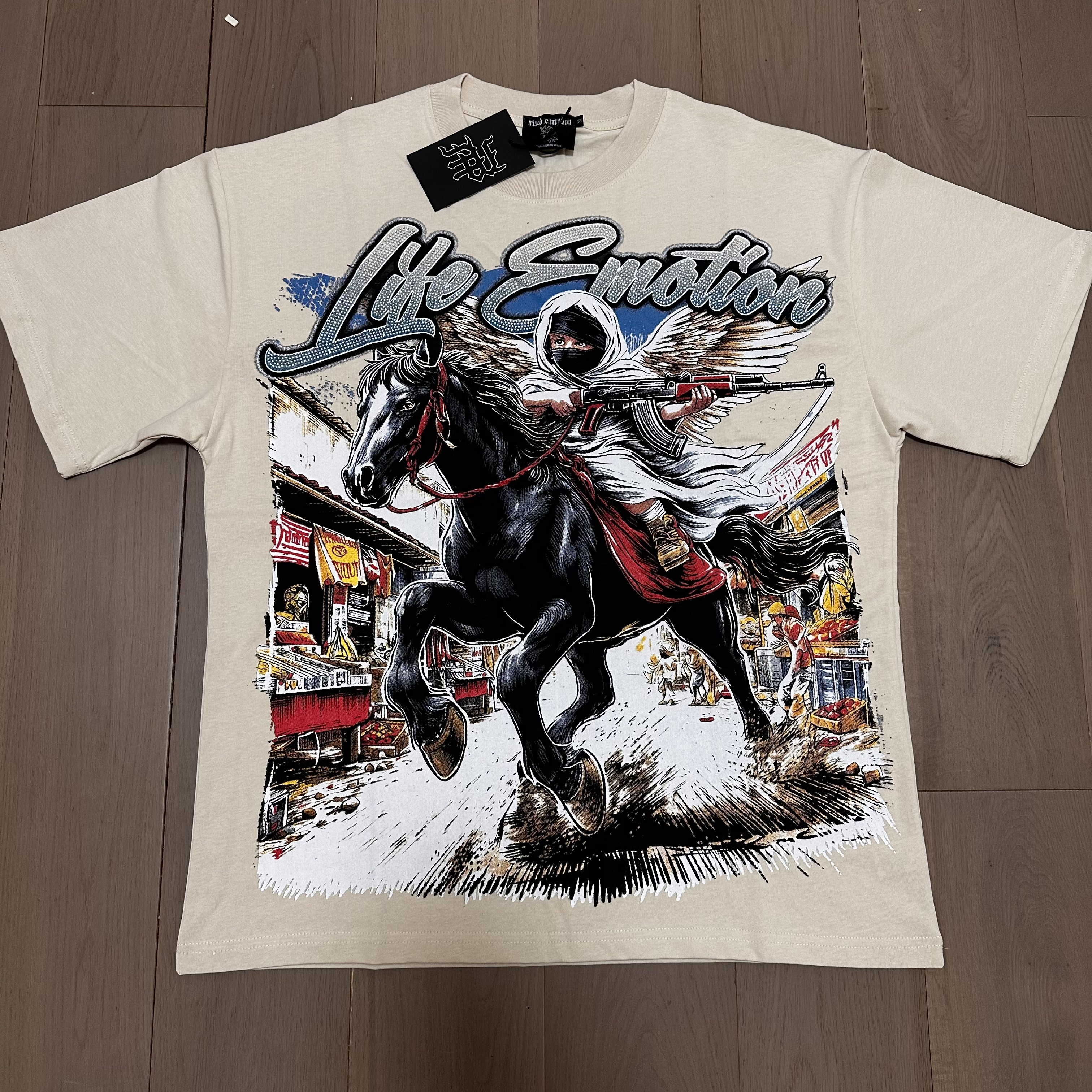 Apricot-colored short-sleeved shirt with a riding angel holding a gun