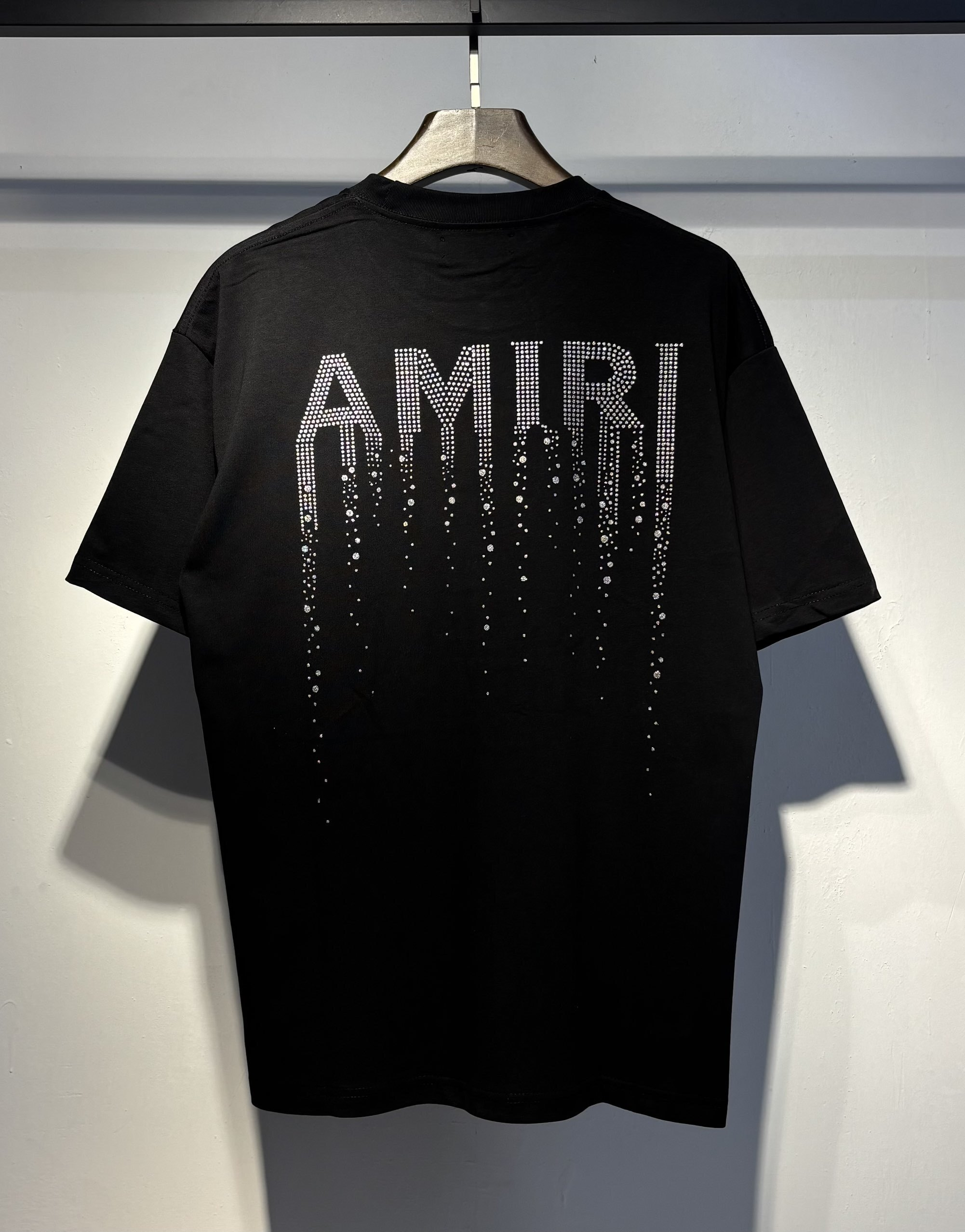 Black diamond-studded meteor with a trailing tail style letter T-shirt