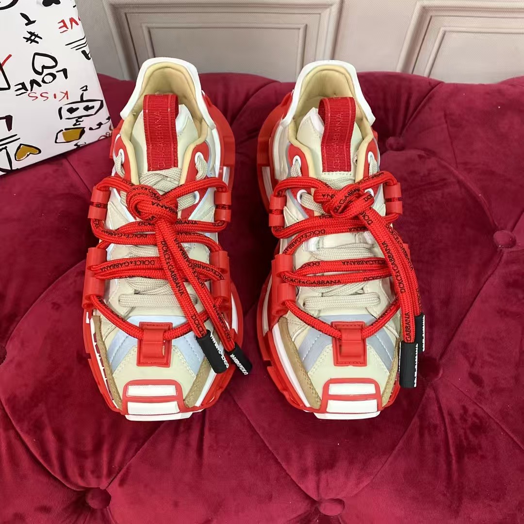 High-quality red laced athletic shoes with a rugged style, reminiscent of a dad's style.