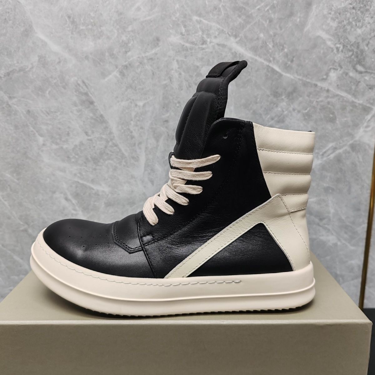 RO Inverted triangle style main strap leather upper with creamy base and dark color high-top shoe