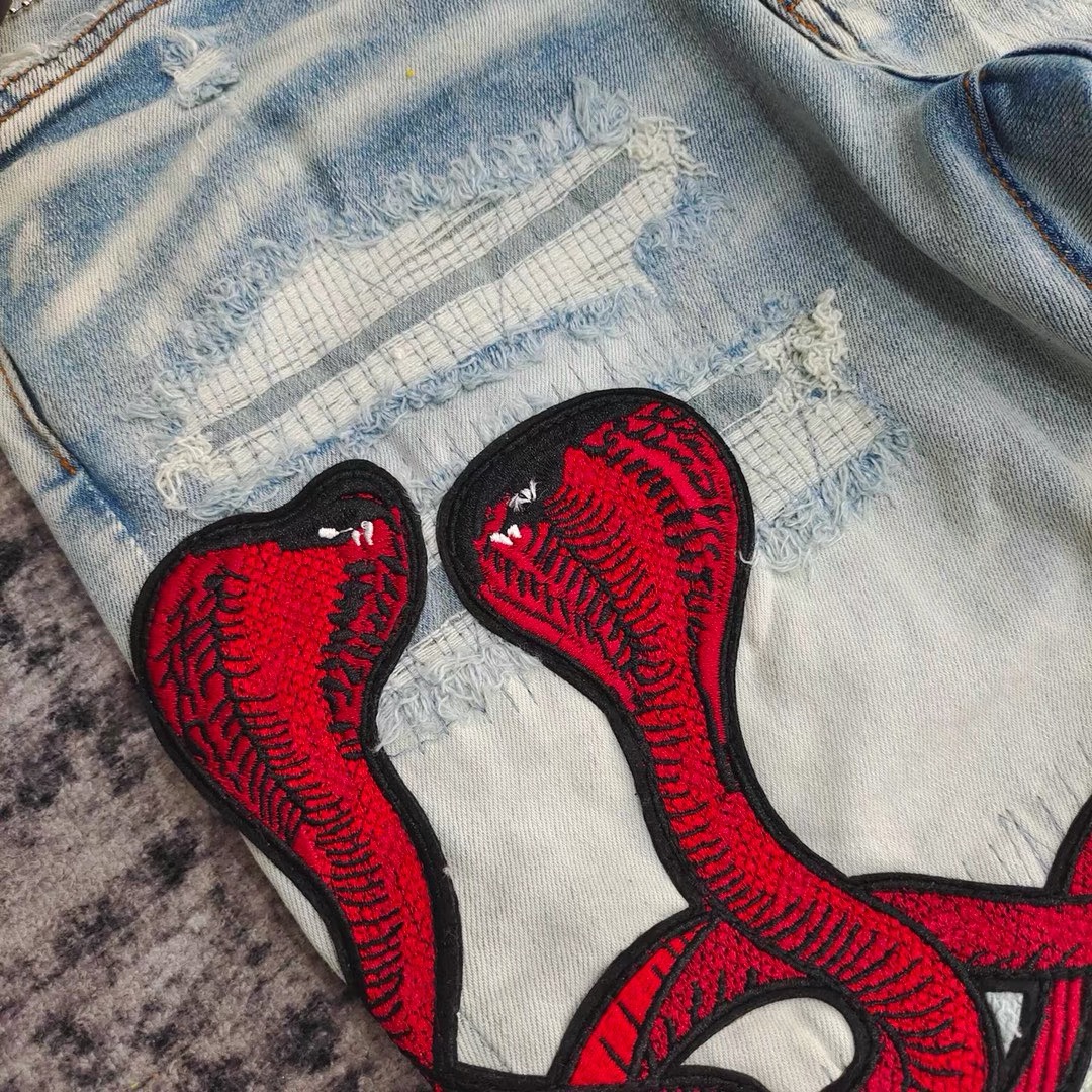amiri red snake embroidered hole patched jeans