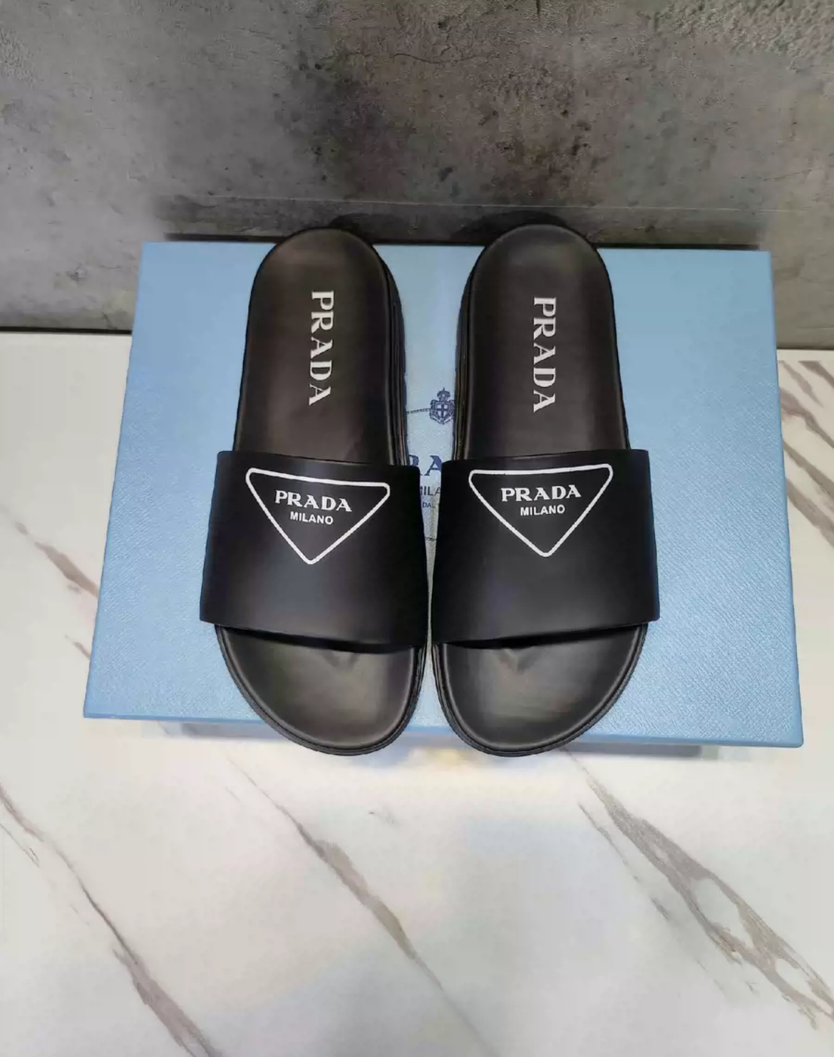 Prada slippers in white and black