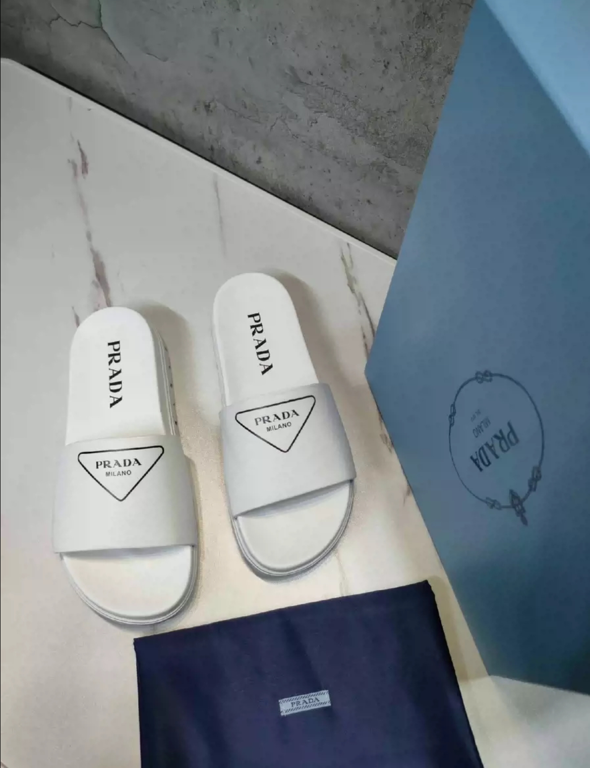 Prada slippers in white and black
