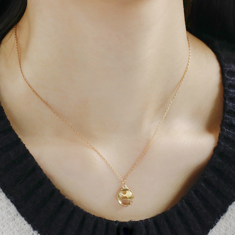 Lazy cat lying on a round lemon crystal pendant necklace