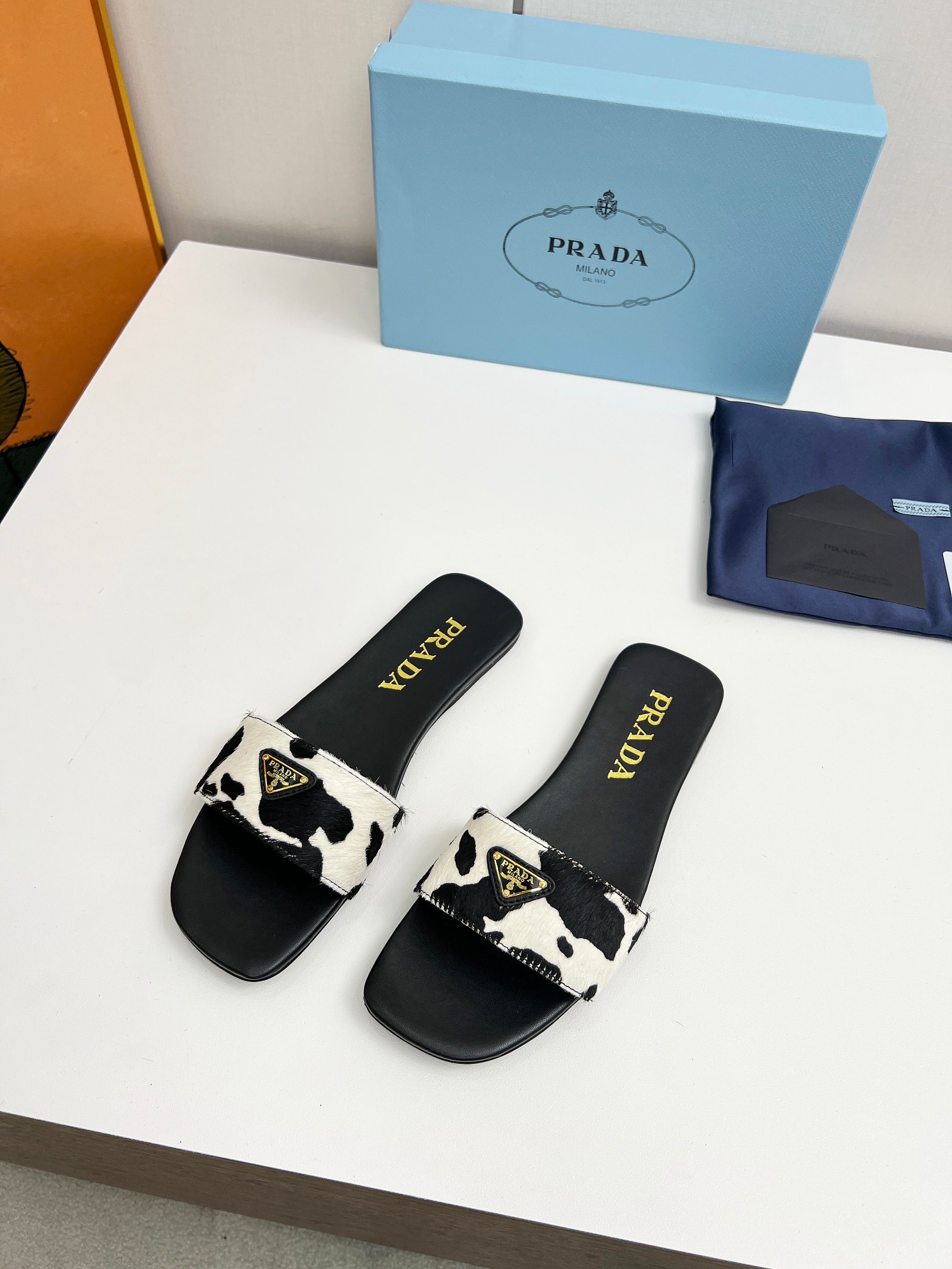 Prada triangle logo cow slides
