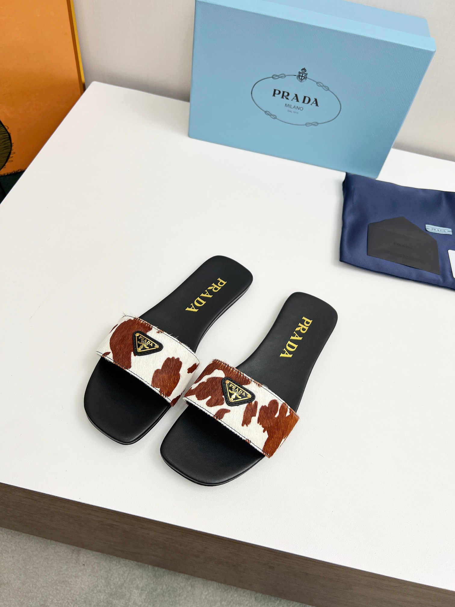 Prada triangle logo cow slides