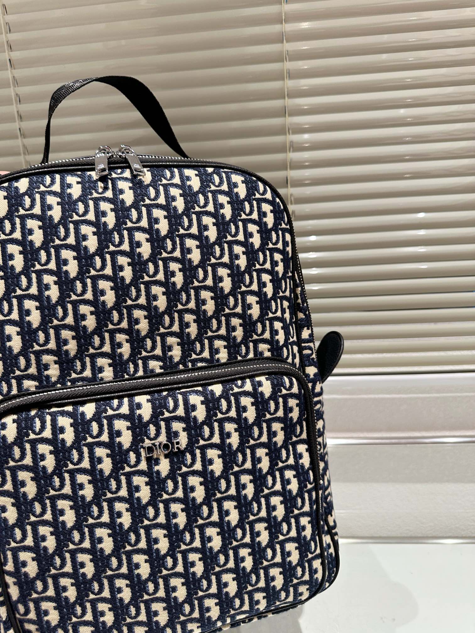 Print and black grained cowhide leather saddle backpack