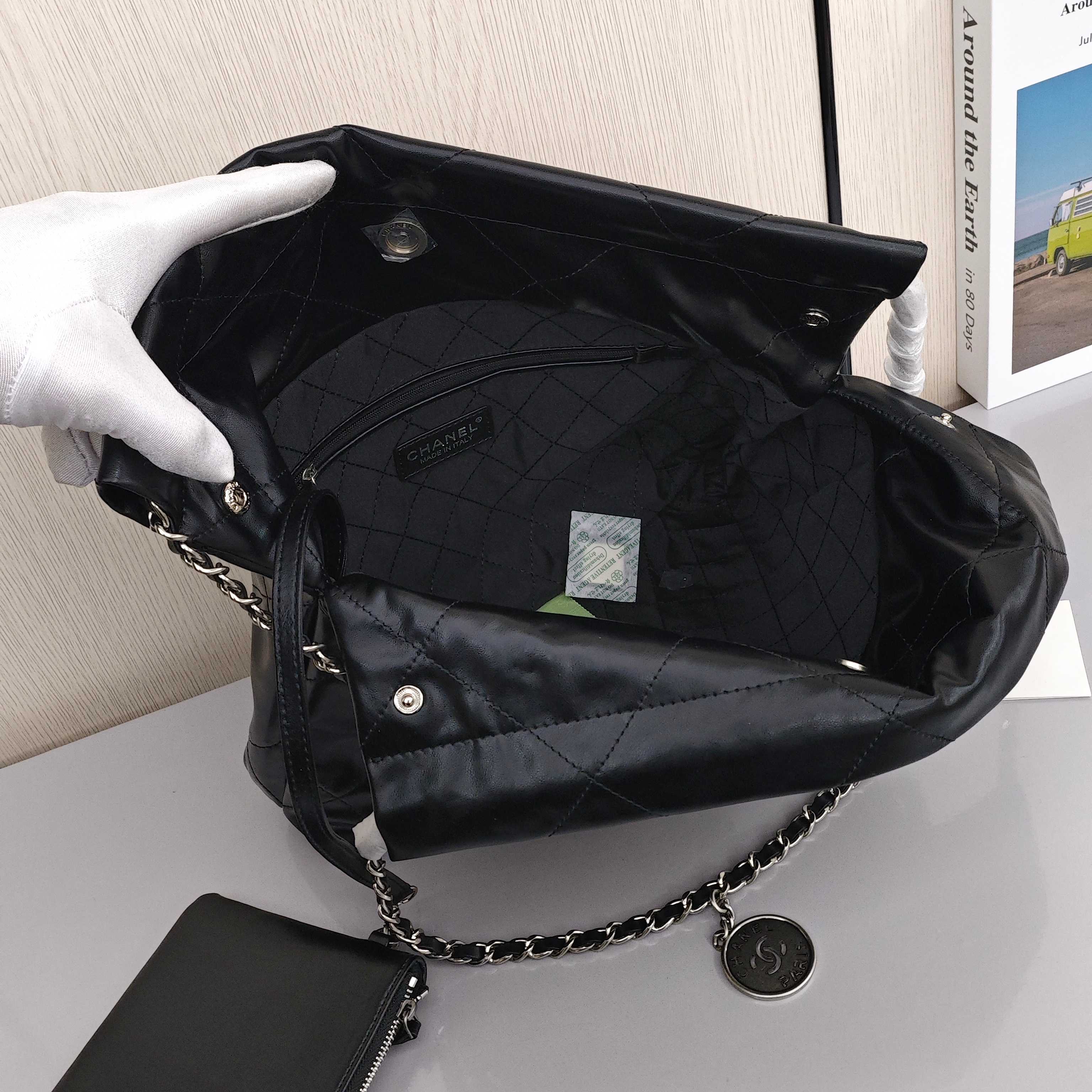 CHANEL 22 Bag Mini. With silver logo, diamond check pattern and drawstring. Made of calfskin. Bucket bag. Can be carried as a crossbody bag or a shoulder bag. Mini size. For women. In black.