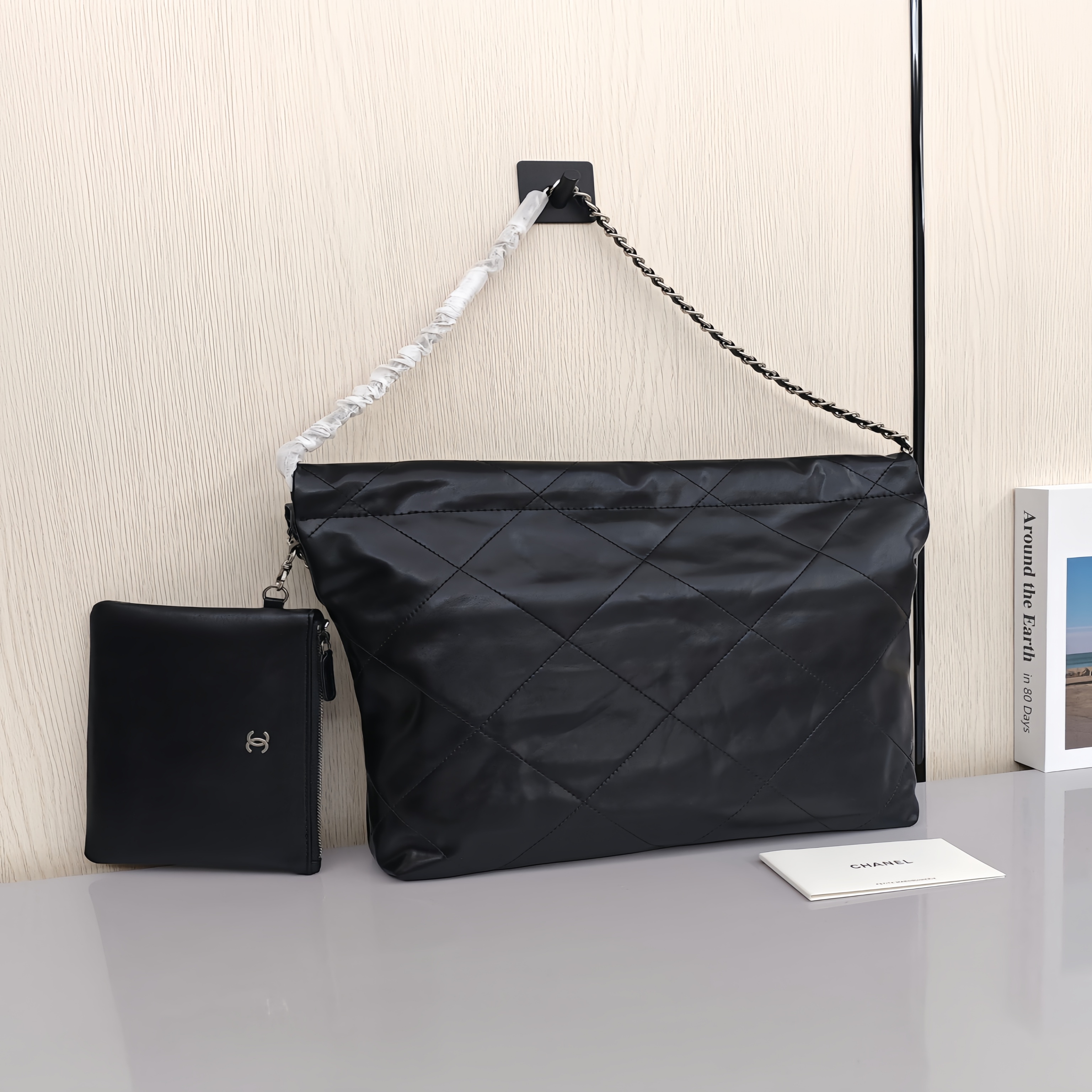 CHANEL 22 Bag Mini. With silver logo, diamond check pattern and drawstring. Made of calfskin. Bucket bag. Can be carried as a crossbody bag or a shoulder bag. Mini size. For women. In black.