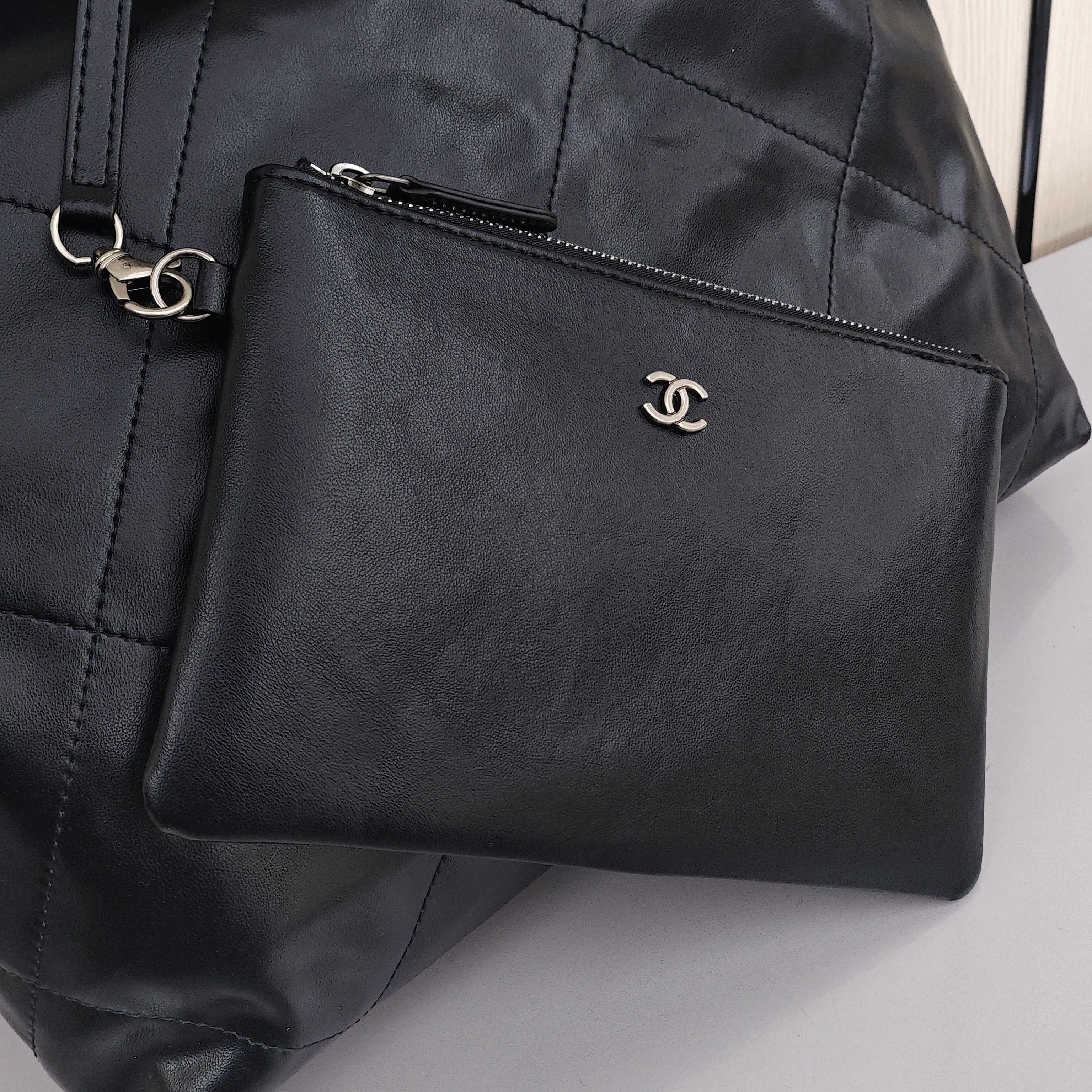 CHANEL 22 Bag Mini. With silver logo, diamond check pattern and drawstring. Made of calfskin. Bucket bag. Can be carried as a crossbody bag or a shoulder bag. Mini size. For women. In black.