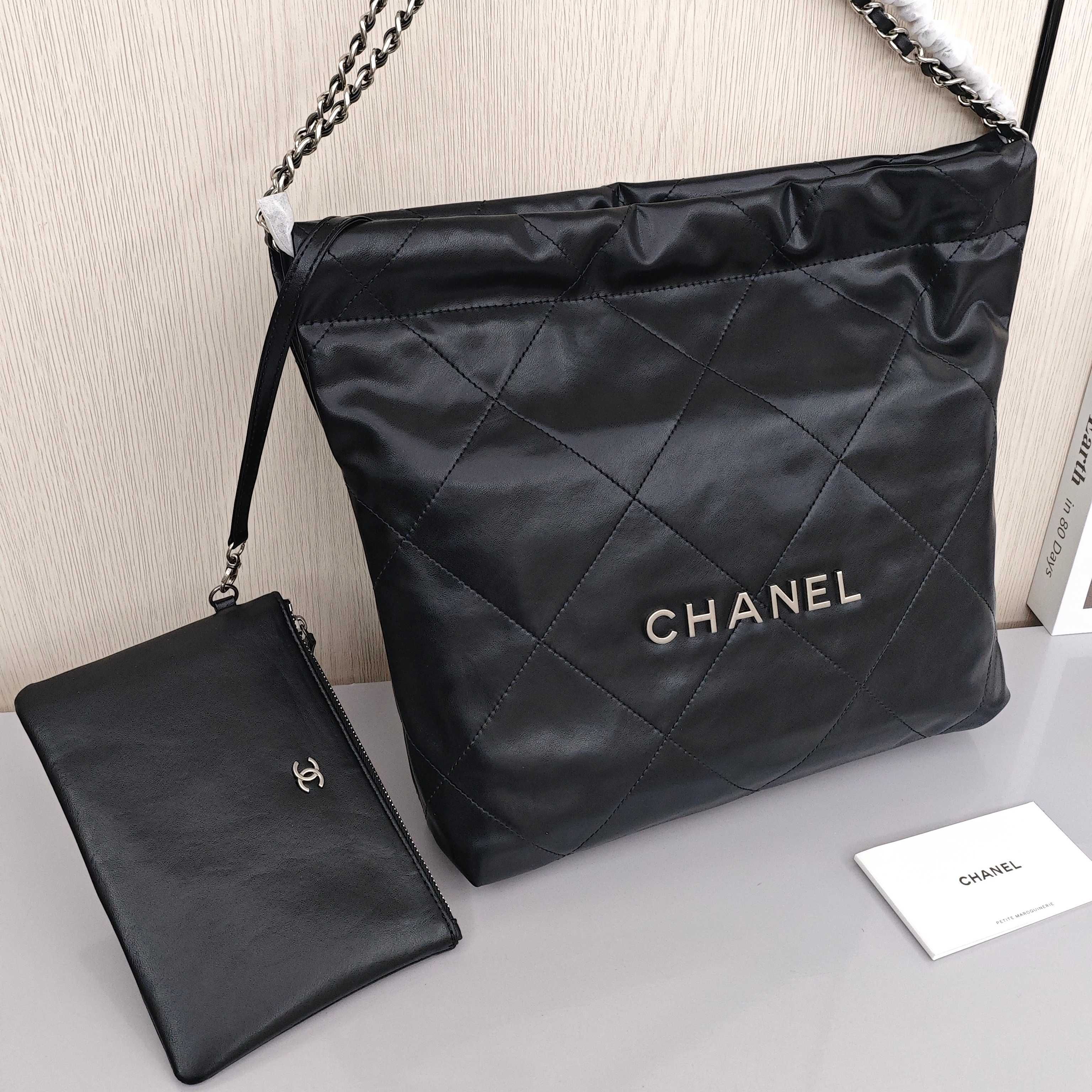 CHANEL 22 Bag Mini. With silver logo, diamond check pattern and drawstring. Made of calfskin. Bucket bag. Can be carried as a crossbody bag or a shoulder bag. Mini size. For women. In black.