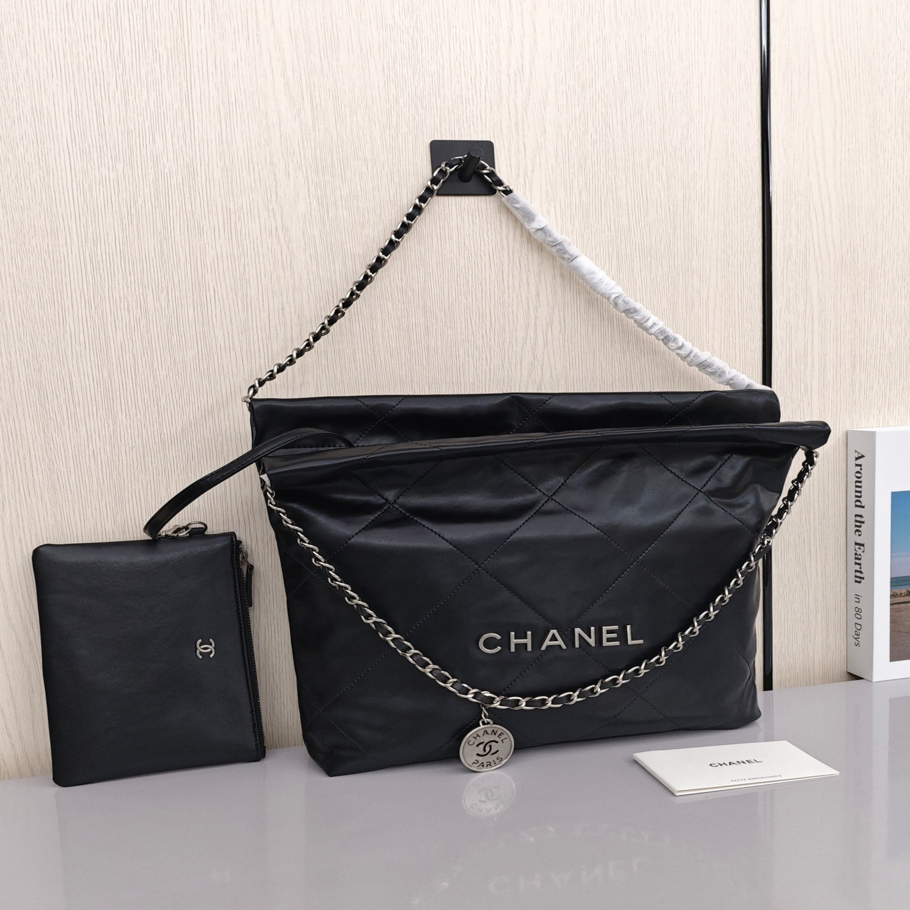 CHANEL 22 Bag Mini. With silver logo, diamond check pattern and drawstring. Made of calfskin. Bucket bag. Can be carried as a crossbody bag or a shoulder bag. Mini size. For women. In black.