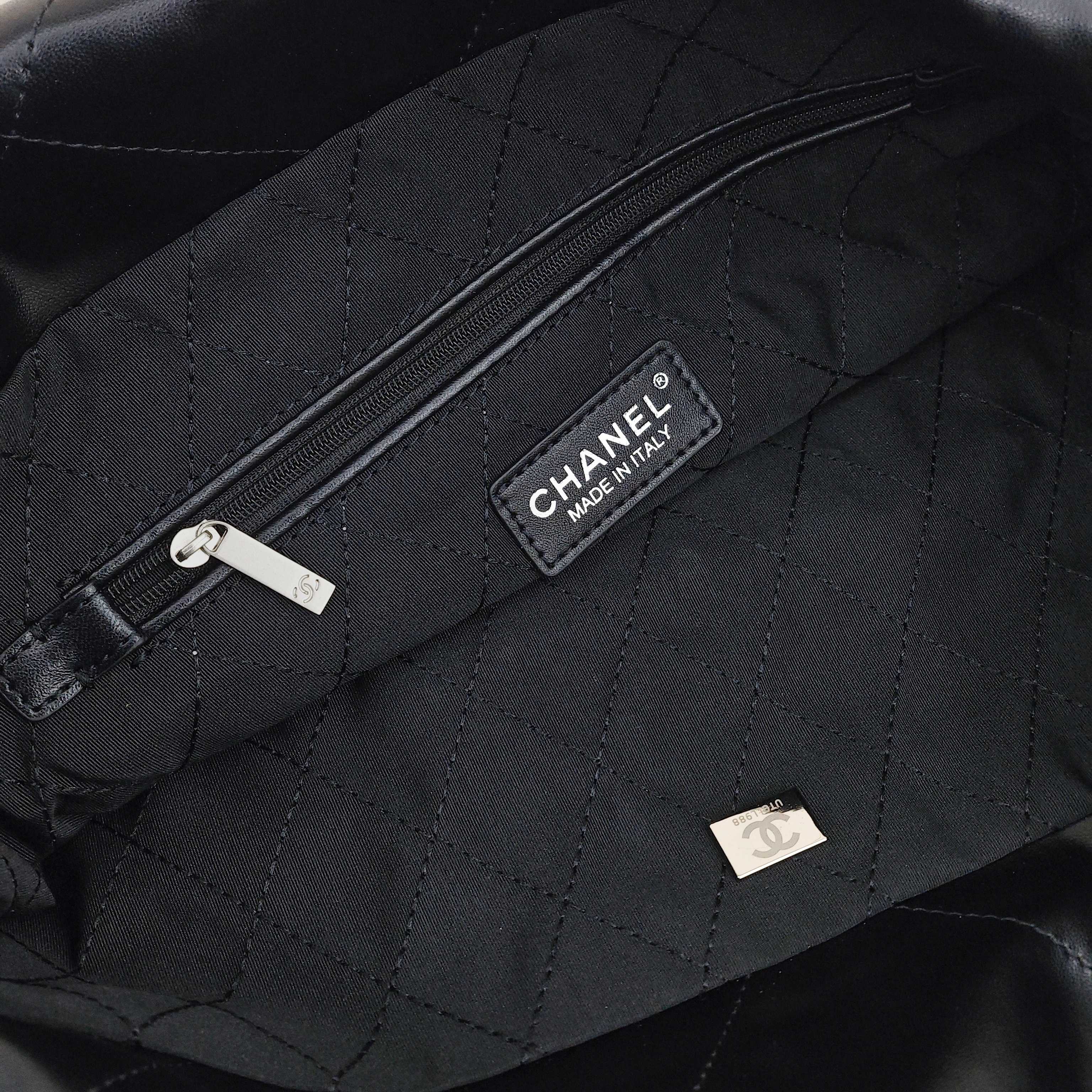 CHANEL 22 Bag Mini. With silver logo, diamond check pattern and drawstring. Made of calfskin. Bucket bag. Can be carried as a crossbody bag or a shoulder bag. Mini size. For women. In black.