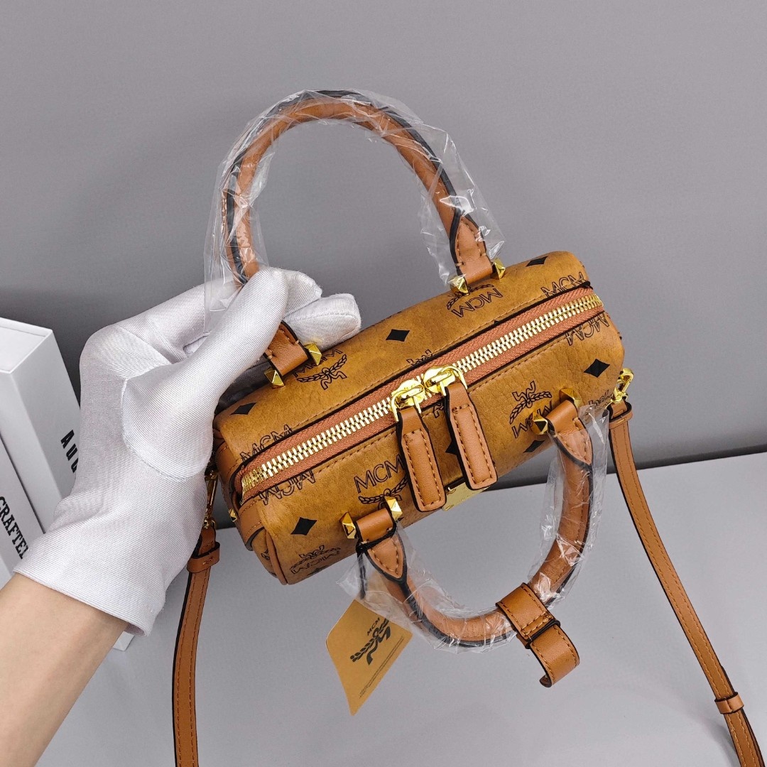 MCM Aren Original Visetos Boston Bag with Leather Trim. Can be carried by hand, worn crossbody or on the shoulder. Unisex Style. Brown.