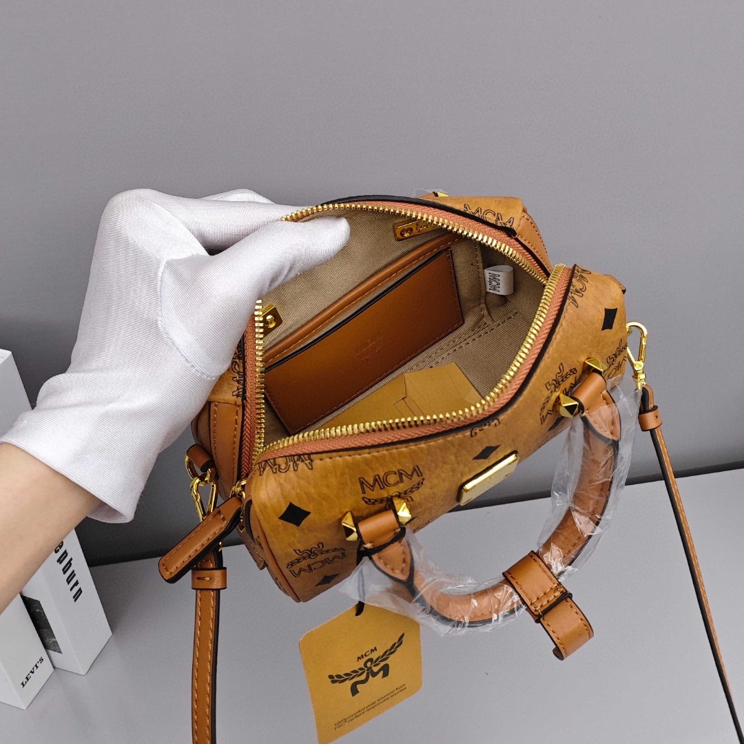 MCM Aren Original Visetos Boston Bag with Leather Trim. Can be carried by hand, worn crossbody or on the shoulder. Unisex Style. Brown.