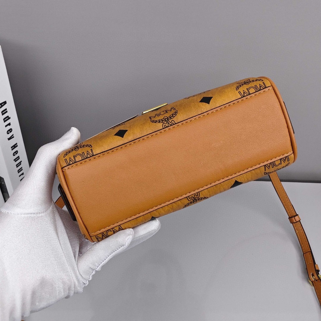 MCM Aren Original Visetos Boston Bag with Leather Trim. Can be carried by hand, worn crossbody or on the shoulder. Unisex Style. Brown.