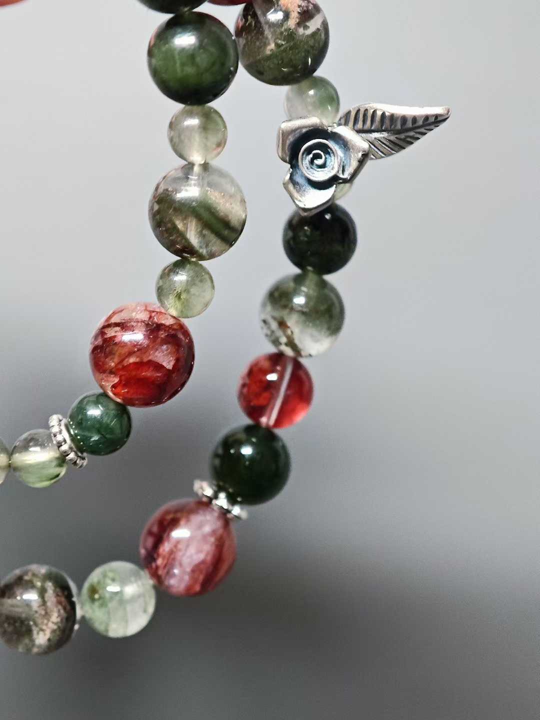 Thorns guard the fragrant cluster,Crimson glows intense beneath the sun.Beauty hides between the spines—Silent, it stands proud against the east wind.