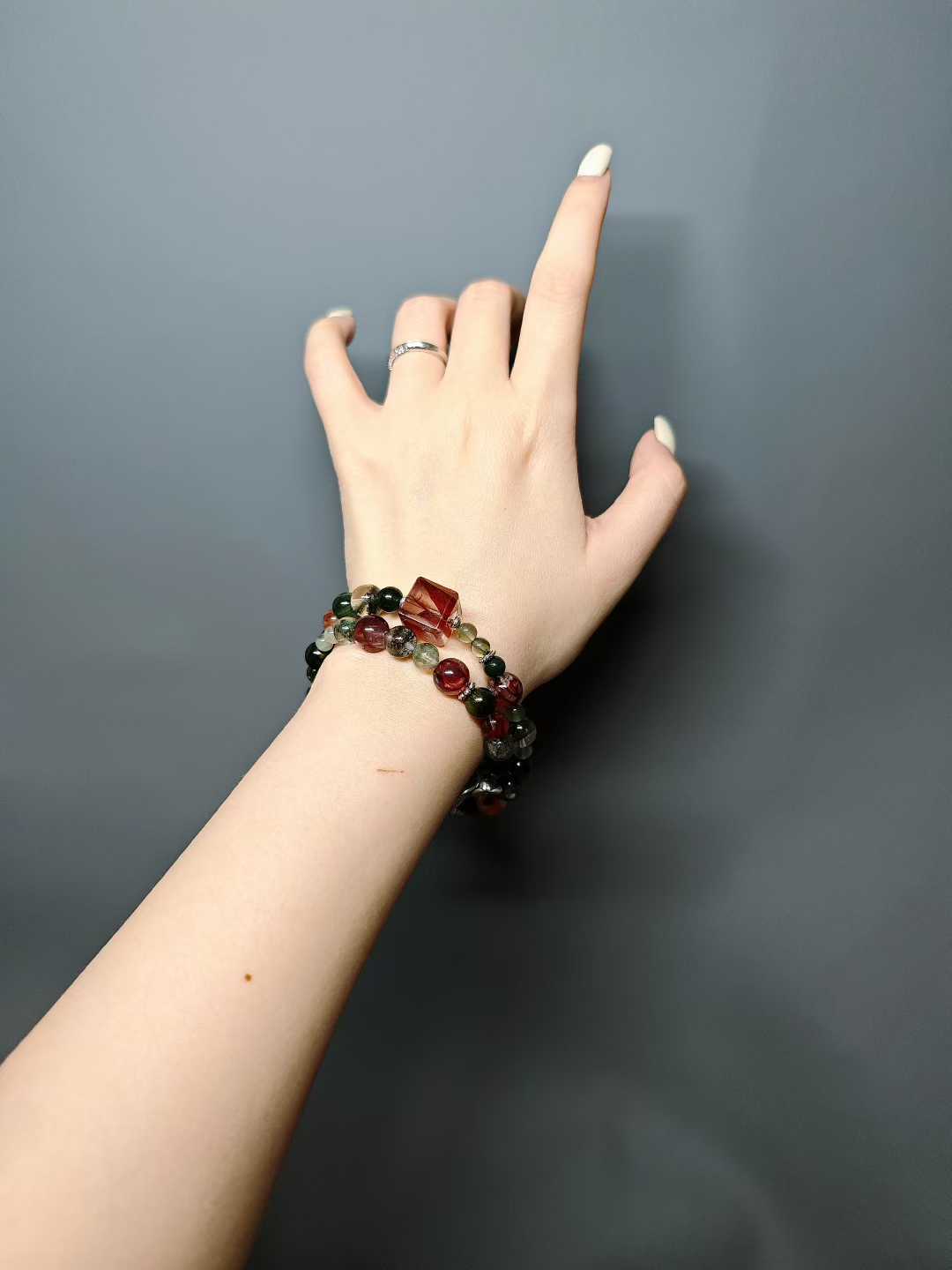 Thorns guard the fragrant cluster,Crimson glows intense beneath the sun.Beauty hides between the spines—Silent, it stands proud against the east wind.