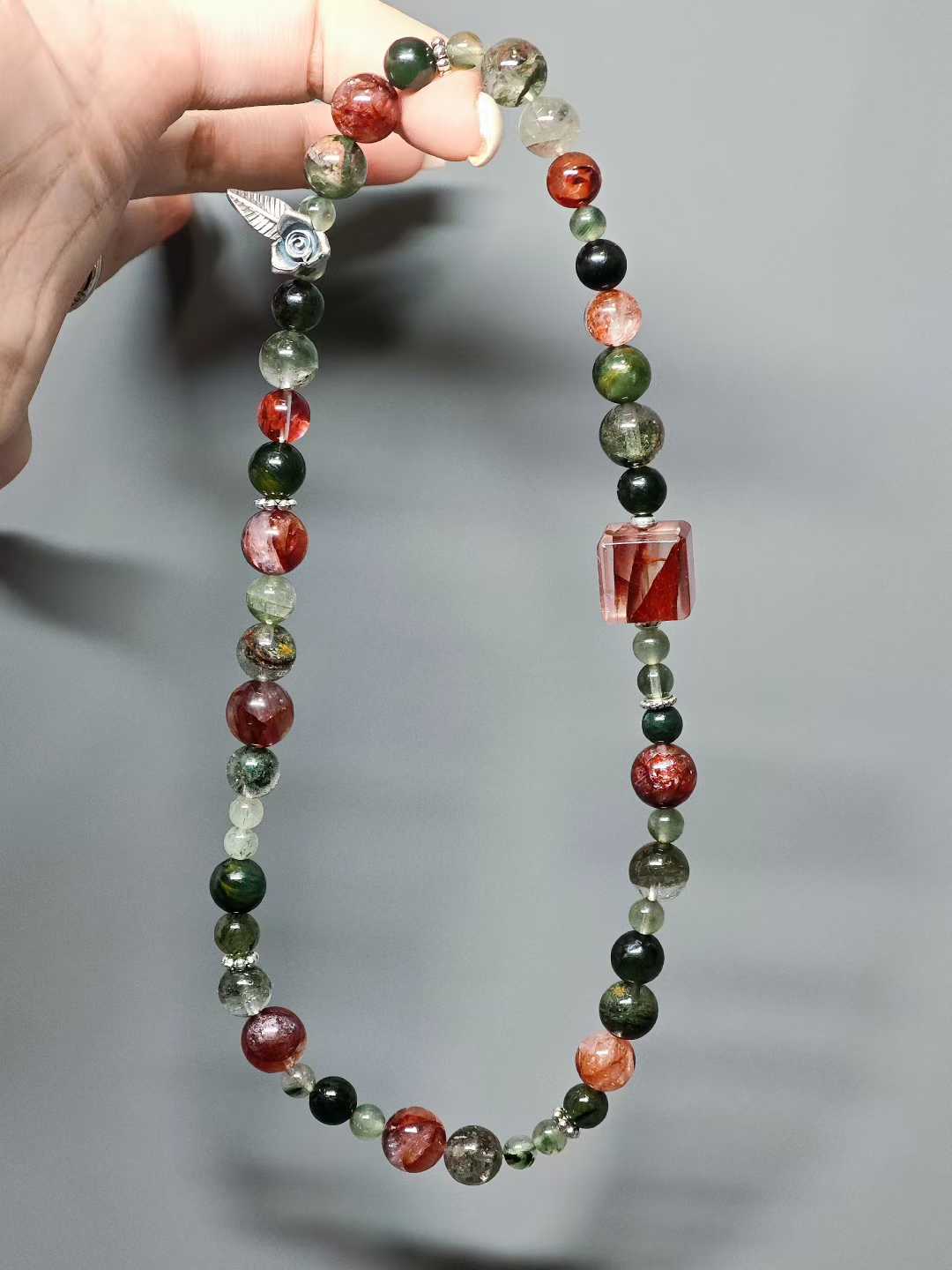 Thorns guard the fragrant cluster,Crimson glows intense beneath the sun.Beauty hides between the spines—Silent, it stands proud against the east wind.