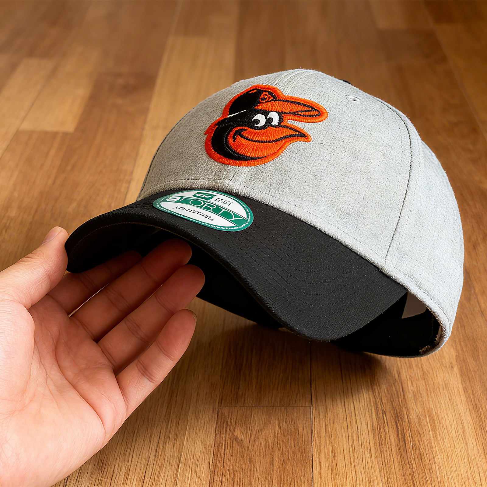 NEW ERA BALTIMORE ORIOLES NEW ERA BLACK MASTER LOGO 950 SNAPBACK HAT. GREY & BLACK