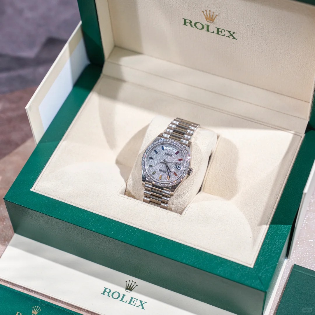 The Oyster Perpetual Day-Date, automatic, 36mm diameter, rainbow indexes, starry dial, 18k white gold case, bezel set with 52 round diamonds. -128349rbr-0006