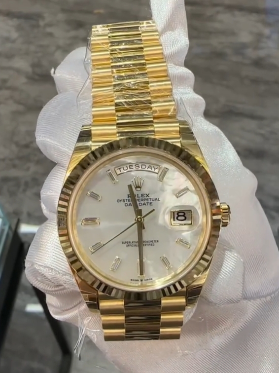 The Oyster Perpetual Day-Date 40 is in 18 ct yellow gold with a diamond-set white mother-of-pearl dial, fluted bezel and President bracelet. -m228238-0071