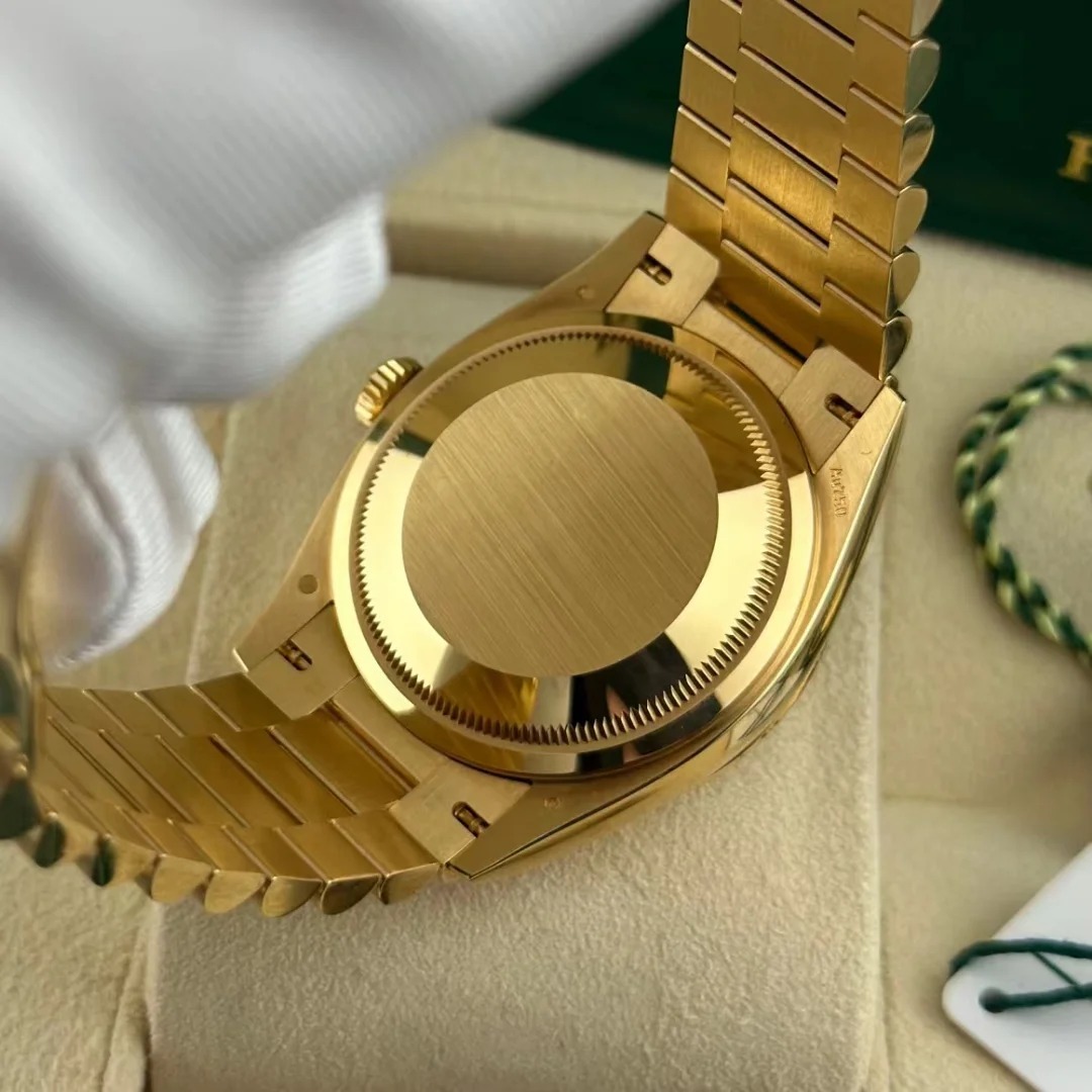 The Oyster Perpetual Day-Date 36 is available in 18 ct yellow gold with a champagne diamond-set dial, fluted bezel and President bracelet. -m128238-0132