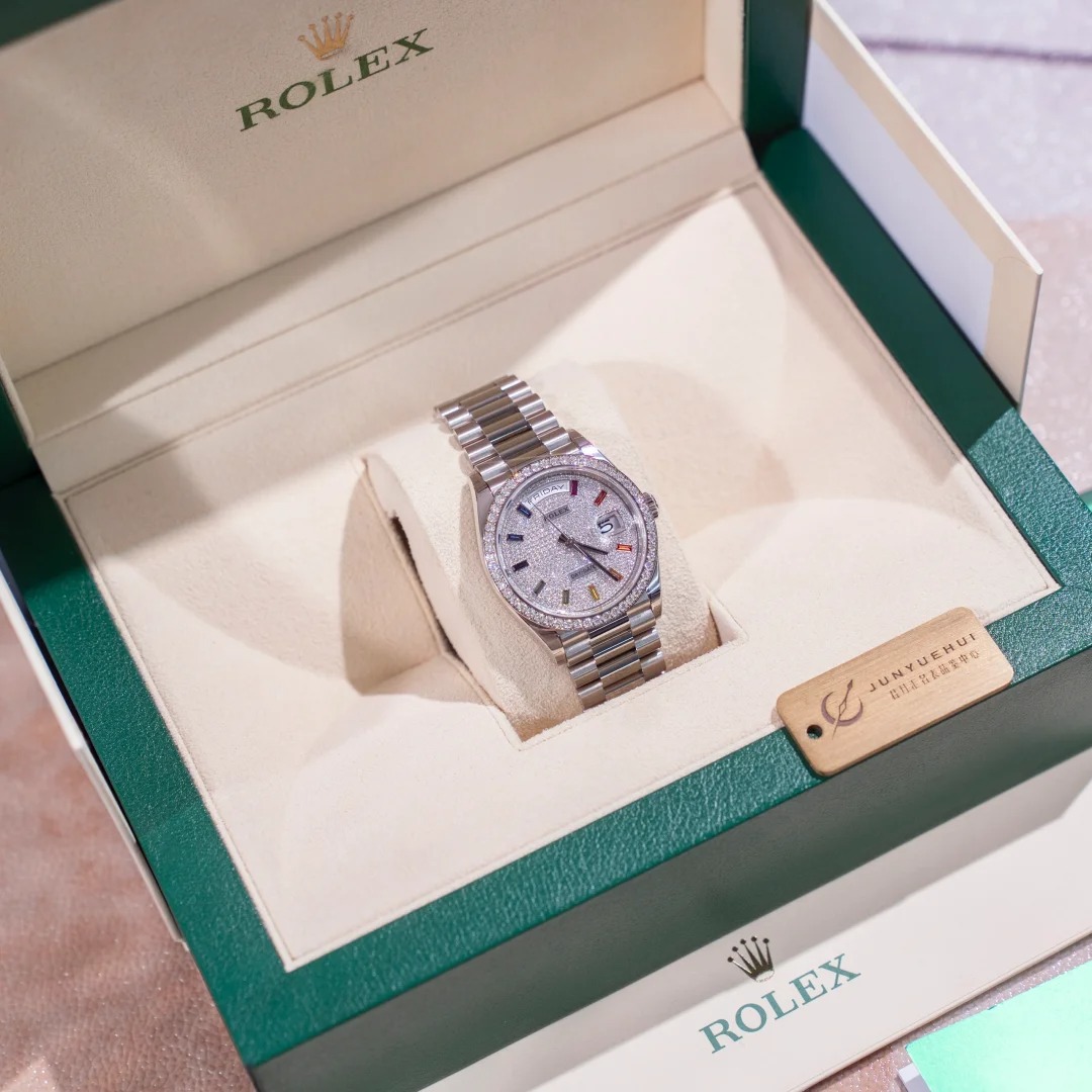 The Oyster Perpetual Day-Date, automatic, 36mm diameter, rainbow indexes, starry dial, 18k white gold case, bezel set with 52 round diamonds. -128349rbr-0006