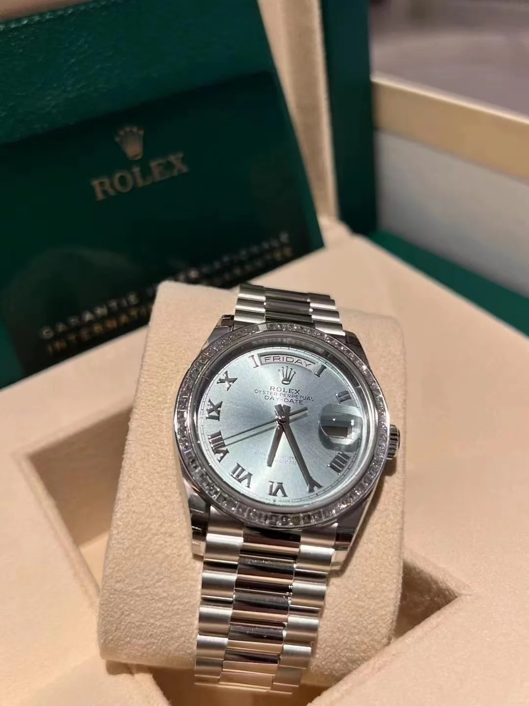 The Oyster Perpetual Day-Date 36 in platinum with an ice-blue dial, diamond-set bezel and President bracelet. -m128396tbr-0019