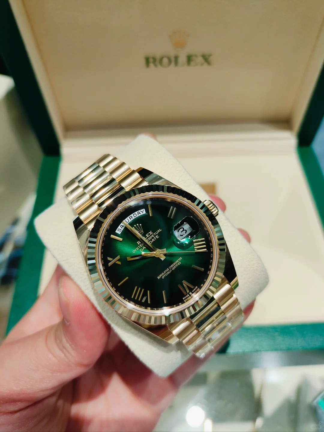 The Oyster Perpetual Day-Date 40 in 18 ct yellow gold with a graduated green dial, fluted bezel and President bracelet. -m228238-0069
