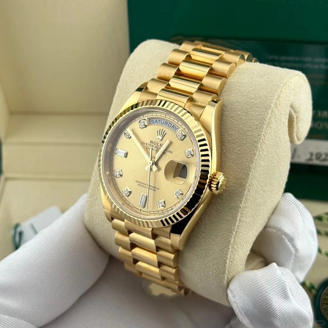 The Oyster Perpetual Day-Date 36 is available in 18 ct yellow gold with a champagne diamond-set dial, fluted bezel and President bracelet. -m128238-0132