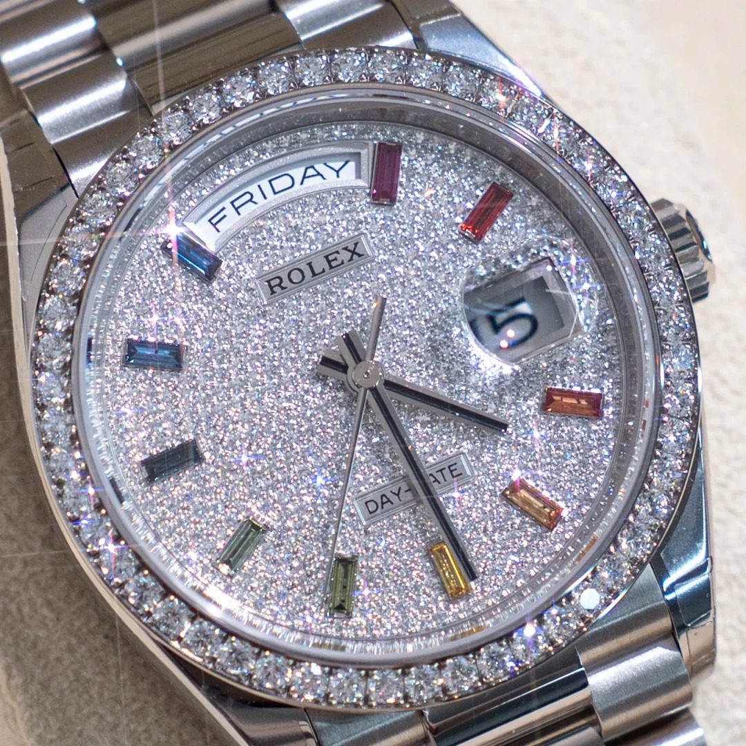 The Oyster Perpetual Day-Date, automatic, 36mm diameter, rainbow indexes, starry dial, 18k white gold case, bezel set with 52 round diamonds. -128349rbr-0006