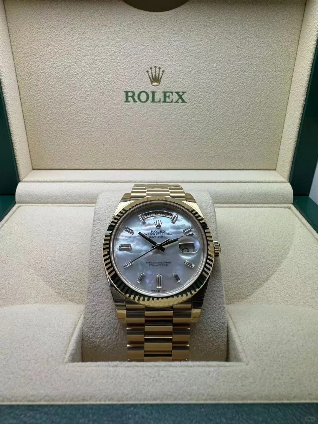 The Oyster Perpetual Day-Date 40 is in 18 ct yellow gold with a diamond-set white mother-of-pearl dial, fluted bezel and President bracelet. -m228238-0071