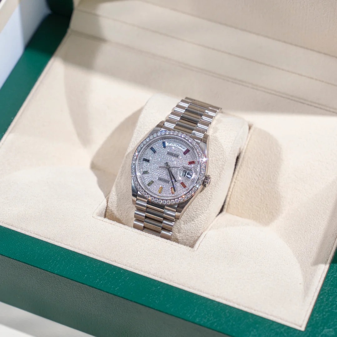 The Oyster Perpetual Day-Date, automatic, 36mm diameter, rainbow indexes, starry dial, 18k white gold case, bezel set with 52 round diamonds. -128349rbr-0006