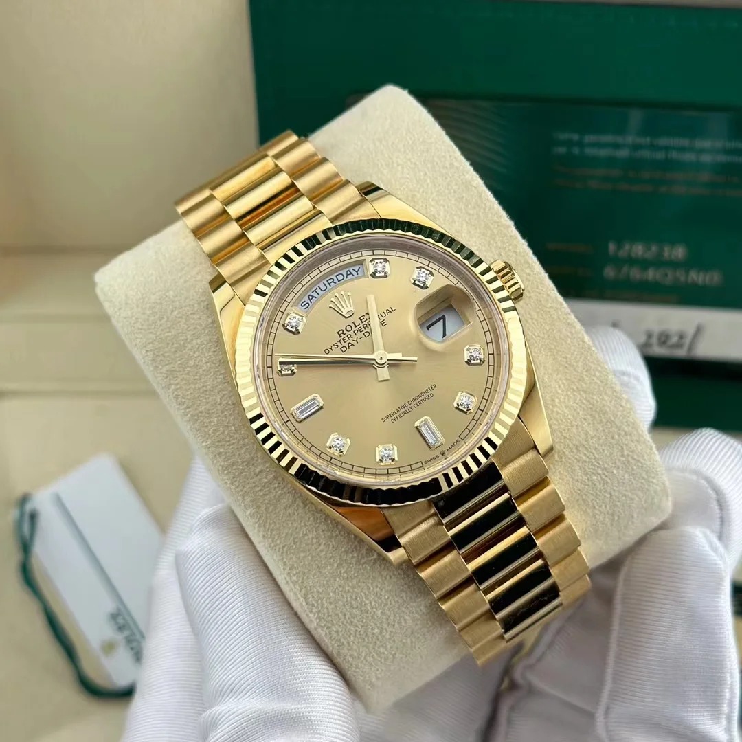 The Oyster Perpetual Day-Date 36 is available in 18 ct yellow gold with a champagne diamond-set dial, fluted bezel and President bracelet. -m128238-0132