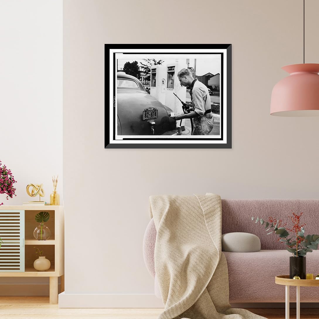 Historic Framed Print, [A Service station attendant measures out gasoline in accordance with the Office of Production Administration's new A gasoline ration books].photo by Liberman., 17-7/8