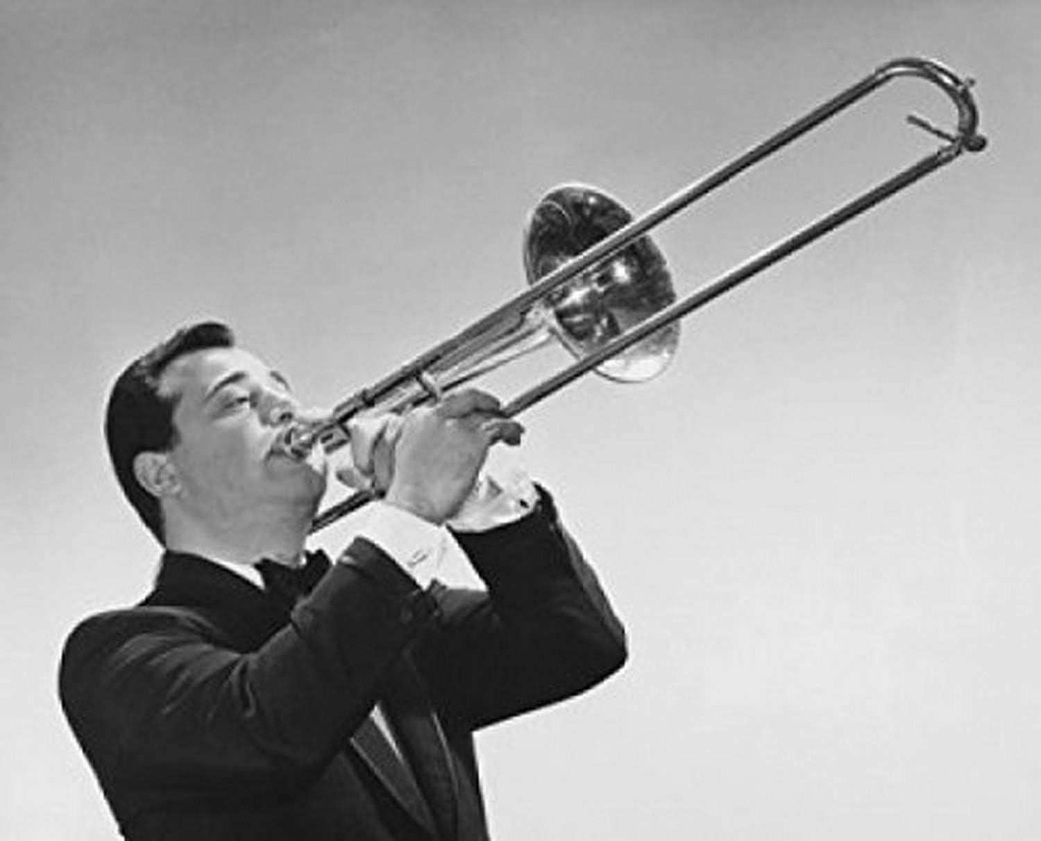 Mid adult man playing a trombone Poster Print (24 x 36)