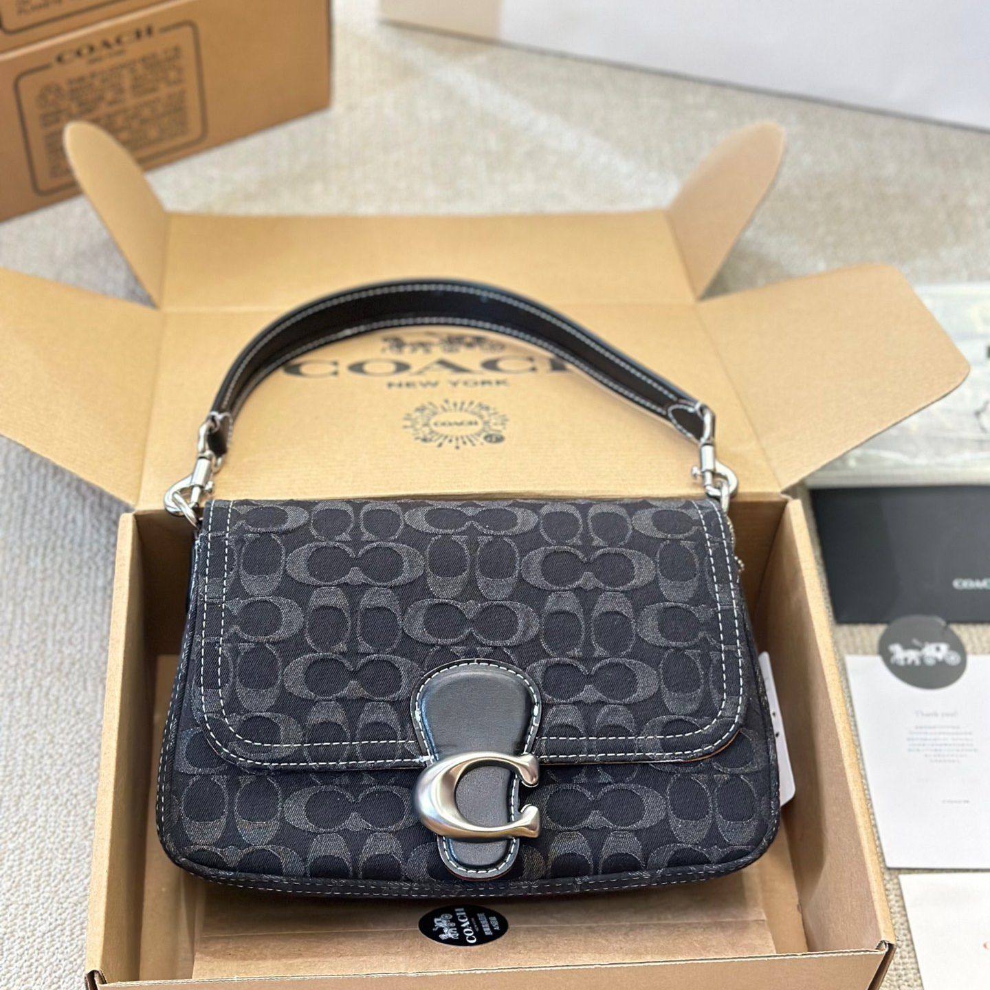 Coach-Embossed denim denim bag